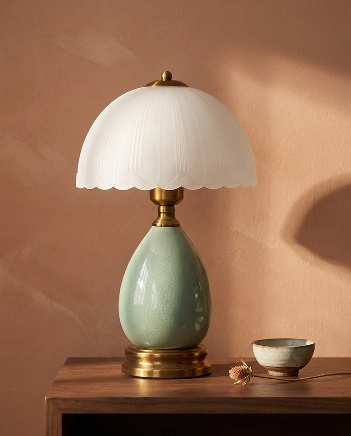 Hand-Blown Ceramic Nightstand Lamp against terracotta wall